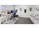 Home office setup with dual monitors, a sit-stand desk, and a comfortable sofa at 14227 Alistar Manor Dr, Wimauma, FL 33598