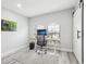 Office with natural light, gray plank flooring, modern desk and chair, and barn door at 14227 Alistar Manor Dr, Wimauma, FL 33598