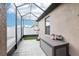 Enclosed patio with basketball hoop and outdoor storage at 14227 Alistar Manor Dr, Wimauma, FL 33598