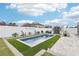 Sparkling in-ground pool with manicured landscaping, lounge seating, and storage shed at 14227 Alistar Manor Dr, Wimauma, FL 33598