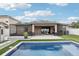 Inviting pool and patio with screened in porch provide the perfect space for outdoor relaxation and entertaining at 14227 Alistar Manor Dr, Wimauma, FL 33598