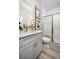 Bright bathroom features modern vanity, sleek fixtures, shower with glass enclosure, and neutral design at 14423 Meadow Bird Ave, Riverview, FL 33579