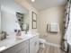 Well-lit bathroom features a double-sink vanity, modern fixtures, and stylish neutral-toned decor at 14423 Meadow Bird Ave, Riverview, FL 33579