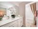 Elegant bathroom with double vanity, quartz countertop, modern fixtures, and decorative orchids at 14423 Meadow Bird Ave, Riverview, FL 33579