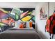 Stylish bedroom with a graffiti-style accent wall and modern decor, creating a unique space at 14423 Meadow Bird Ave, Riverview, FL 33579