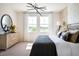Stylish bedroom features modern decor, lots of light, and a decorative wall design at 14423 Meadow Bird Ave, Riverview, FL 33579
