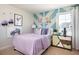 Charming bedroom with whimsical wall decor, bright lighting, and colorful accents at 14423 Meadow Bird Ave, Riverview, FL 33579