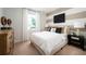 Cozy bedroom boasts contemporary decor, a decorative wall design, and a view from the window at 14423 Meadow Bird Ave, Riverview, FL 33579
