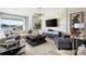 Bright living room featuring a contemporary design with decorative fireplace, stylish furniture, and views of the lake at 14423 Meadow Bird Ave, Riverview, FL 33579