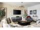 Living room featuring neutral tones, a modern stone accent wall with a television, and decorative art at 14423 Meadow Bird Ave, Riverview, FL 33579