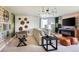 Inviting living room features cozy seating, accent furniture, and a foosball table at 14423 Meadow Bird Ave, Riverview, FL 33579
