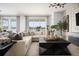 A spacious living room features contemporary design with views of the outdoors and a stylish sectional sofa at 14423 Meadow Bird Ave, Riverview, FL 33579