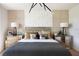 A stylish main bedroom features decorative pillows, mirrored nightstands, and a modern chandelier at 14423 Meadow Bird Ave, Riverview, FL 33579