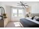A bright main bedroom features decorative furniture and decor, and large windows with an exterior view at 14423 Meadow Bird Ave, Riverview, FL 33579