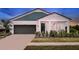 Charming single-Gathering home with a two-car garage, manicured lawn and inviting covered porch at 14427 Meadow Bird Ave, Riverview, FL 33579