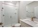 Modern bathroom with glass enclosed shower, white textured tile and vanity at 14433 Meadow Bird Ave, Riverview, FL 33579