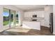Bright kitchen features white cabinets, an island with a sink and stainless steel appliances at 14433 Meadow Bird Ave, Riverview, FL 33579