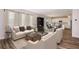 Bright living room with hardwood floors offers an open-concept to kitchen and dining areas at 14433 Meadow Bird Ave, Riverview, FL 33579