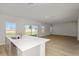 Kitchen and open-plan living area with wood floors, sliding door, and modern finishes at 14789 Summer Branch Dr, Lithia, FL 33547