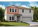 Charming two-story home with a neutral palette, attached garage, and well-manicured front lawn at 14803 Summer Branch Dr, Lithia, FL 33547