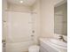 Clean, well-lit bathroom featuring a tub with shower and modern sink at 14811 Summer Branch Dr, Lithia, FL 33547