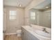 Modern bathroom with double sinks, a large mirror, and a shower-tub combo at 14811 Summer Branch Dr, Lithia, FL 33547