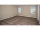 Spacious bedroom with plush carpeting, neutral walls, and two windows at 14811 Summer Branch Dr, Lithia, FL 33547