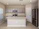 Modern kitchen featuring gray cabinetry, stainless steel appliances, and a center island with quartz countertop at 14811 Summer Branch Dr, Lithia, FL 33547