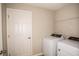 Convenient laundry room featuring a new washer and dryer set with a storage shelf above at 14811 Summer Branch Dr, Lithia, FL 33547