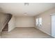 Bright and airy living room with wood-look floors, staircase and multiple windows at 14811 Summer Branch Dr, Lithia, FL 33547