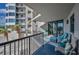Spacious balcony with comfortable seating, beautiful views of the complex and lush tropical landscaping at 1600 Gulf Blvd # 212, Clearwater Beach, FL 33767
