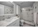 Charming bathroom with a marble sink vanity, white shaker cabinets, and glass-enclosed shower at 1600 Gulf Blvd # 212, Clearwater Beach, FL 33767
