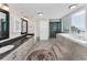 A spacious bathroom featuring a soaking tub, walk-in shower, and dual sink vanity, with direct access to balcony at 1600 Gulf Blvd # 212, Clearwater Beach, FL 33767