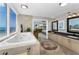 Bright bathroom featuring a large tub with jets, dual sinks, and serene ocean views, adjacent to main bedroom at 1600 Gulf Blvd # 212, Clearwater Beach, FL 33767