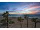 Beautiful beachfront view with palm trees and colorful sky at sunset at 1600 Gulf Blvd # 212, Clearwater Beach, FL 33767