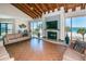 Bright living room with wood-beamed ceilings, fireplace, and amazing beachfront views at 1600 Gulf Blvd # 212, Clearwater Beach, FL 33767