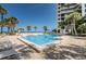 Enjoy the community pool and beach access with lounge seating and tropical landscaping at 1600 Gulf Blvd # 212, Clearwater Beach, FL 33767