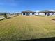 A newly constructed home with a vast backyard featuring a freshly manicured lawn at 209 Lazy Shore Dr, Nokomis, FL 34275