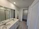 Bright bathroom with double sinks, shower and linen closet is a great amenity at 209 Lazy Shore Dr, Nokomis, FL 34275