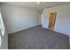 Clean bedroom features neutral carpets, natural light and is adjoined with a bathroom at 209 Lazy Shore Dr, Nokomis, FL 34275