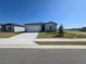 Charming single-story home with a well-manicured lawn and a two-car garage at 209 Lazy Shore Dr, Nokomis, FL 34275