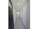 Inviting hallway with ceramic floors and neutral paint provides a welcoming entry at 209 Lazy Shore Dr, Nokomis, FL 34275