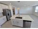 Stylish kitchen island with a stainless dishwasher compliments the open living space at 209 Lazy Shore Dr, Nokomis, FL 34275