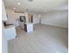 Open concept kitchen and living area featuring a kitchen island and tiled floors at 209 Lazy Shore Dr, Nokomis, FL 34275