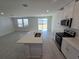 Open concept kitchen and living room boasts island with stainless faucet, oven and natural light at 209 Lazy Shore Dr, Nokomis, FL 34275