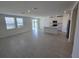 Bright and spacious living area with tile flooring, adjoining a modern kitchen and backyard access at 209 Lazy Shore Dr, Nokomis, FL 34275