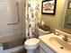 Cozy bathroom with white tiled shower and tub combo and a colorful fish themed shower curtain at 2513 Oakleaf Ln # 26C, Clearwater, FL 33763