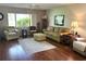 Cozy living room with wood floors, a large window, and comfortable seating, creating an inviting space at 2513 Oakleaf Ln # 26C, Clearwater, FL 33763