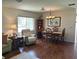 Comfortable living area with wood floors, a dining table and chairs under a chandelier at 2513 Oakleaf Ln # 26C, Clearwater, FL 33763