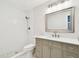 Modern bathroom featuring a glass-enclosed shower, a vanity, new lighting, and a toilet at 2650 Countryside Blvd # B-110, Clearwater, FL 33761